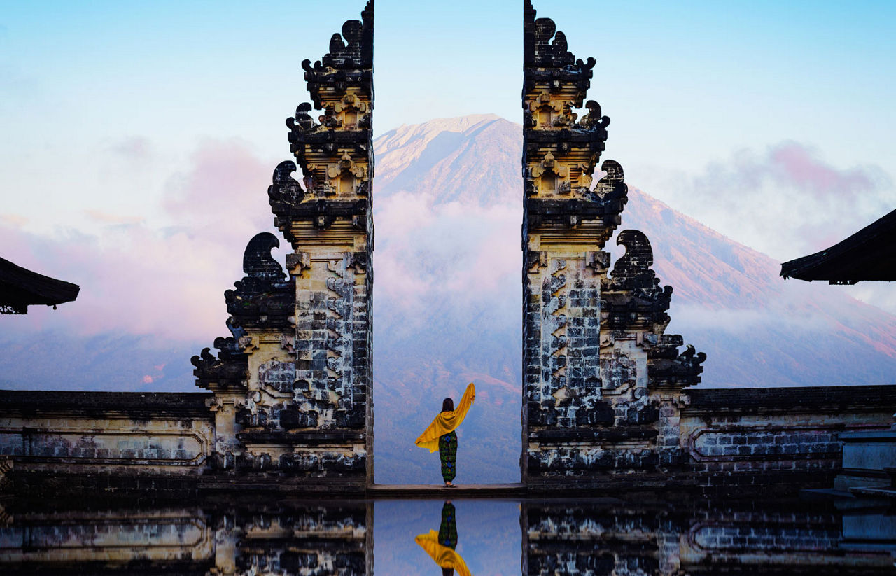 Female tourist at temple gates of heaven Bali Indonesia
