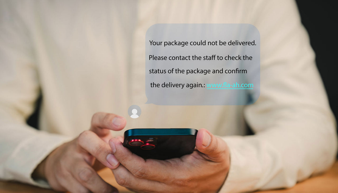 Person holds a smartphone displaying a notification about a failed package delivery. This message user to contact support and confirm delivery. Fake Text message SMS scam or phishing concept.