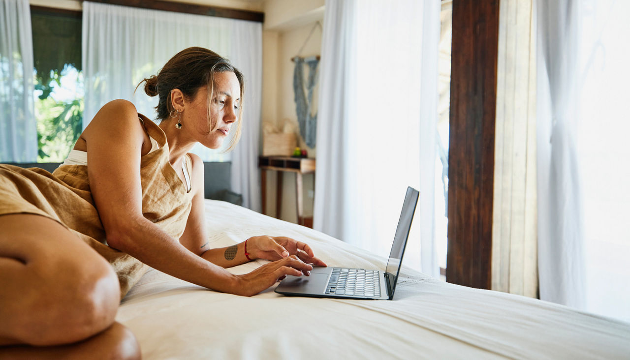 Woman on her laptop checking her email while traveling