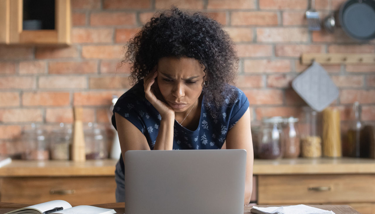 Frustrated woman using laptop