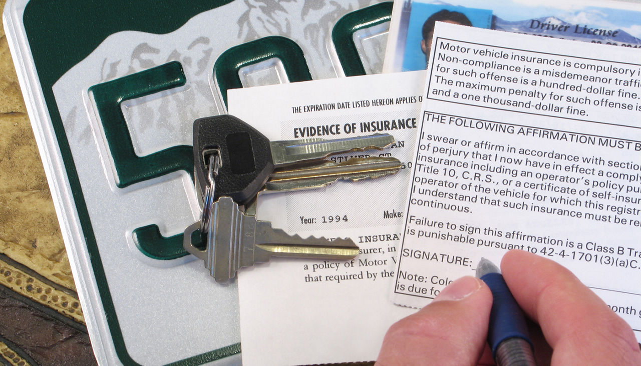 License Plate, Keys, and Papers Proving Evidence of Auto Insurance