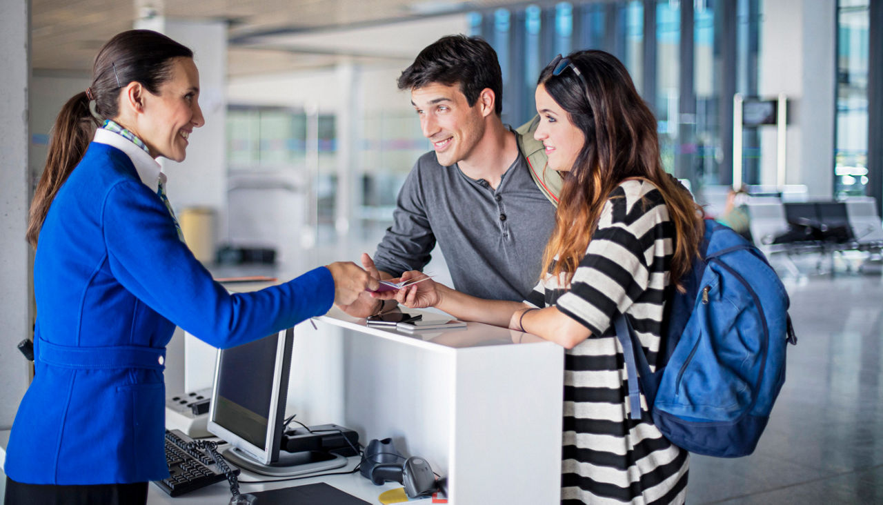 Young couple boarding to the plane at airport