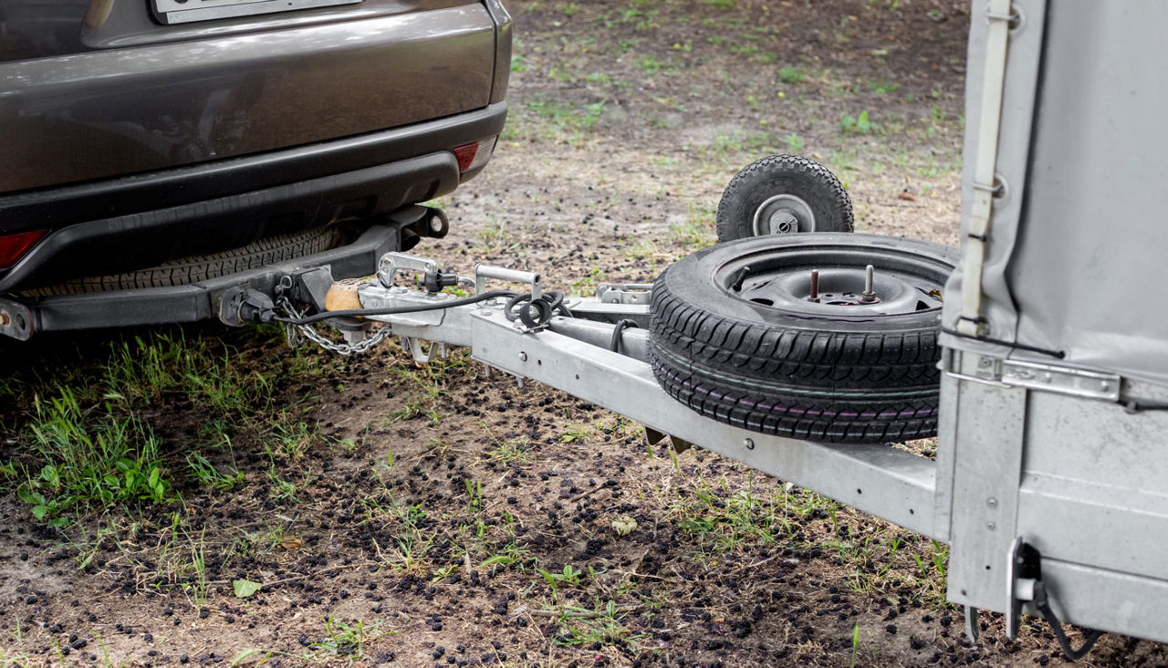 Tow hitch on a car. Trailer drawbar with spare wheel