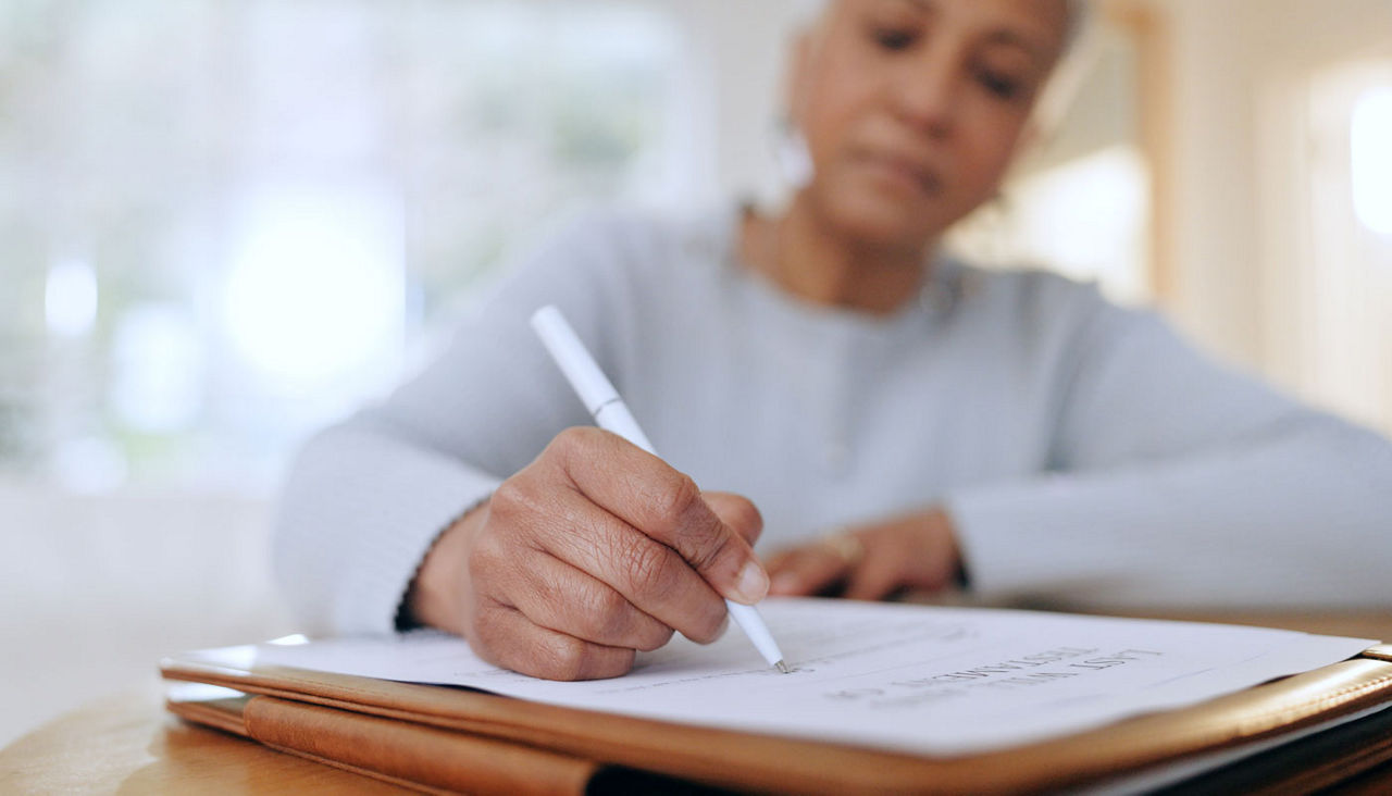 Person, hand and checklist, investment or will in retirement with signature in home