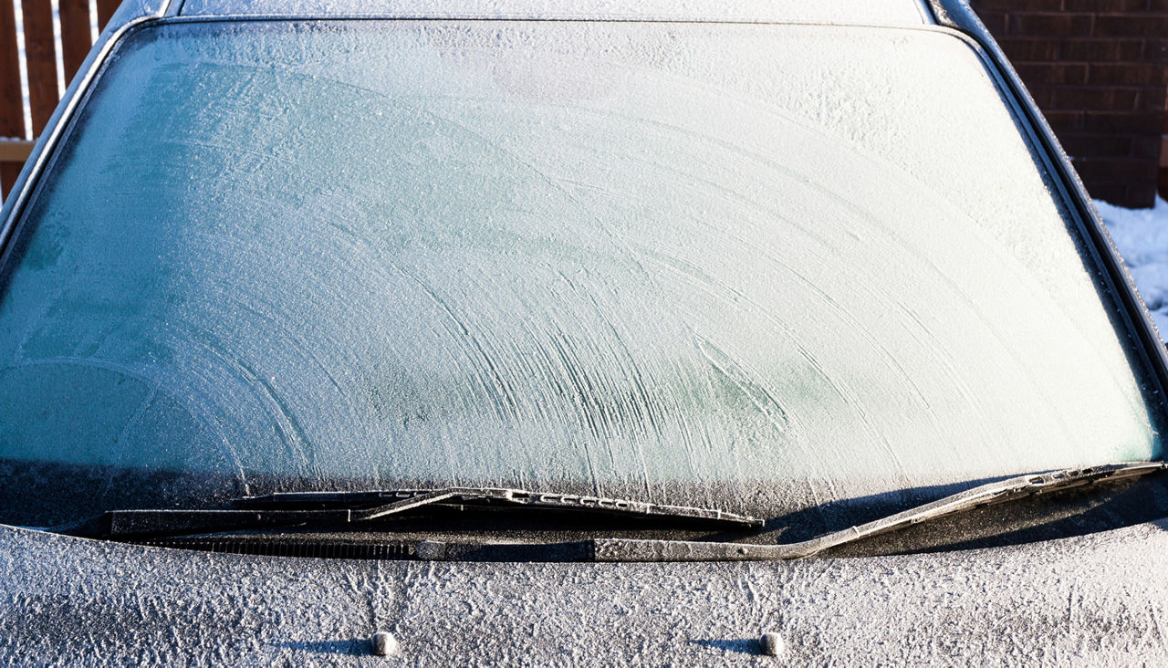 Frosty patterns on a completely covered car windscreen