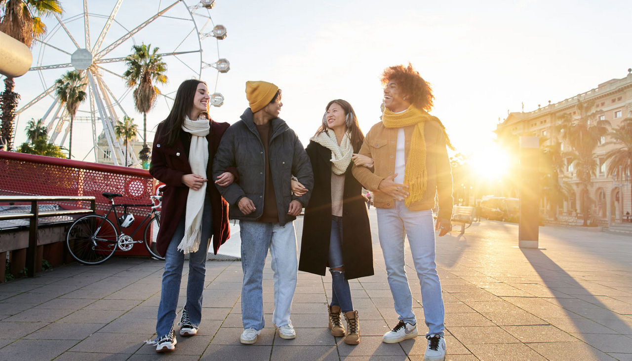 Group of best friends hanging out together at an amusement park in the winter