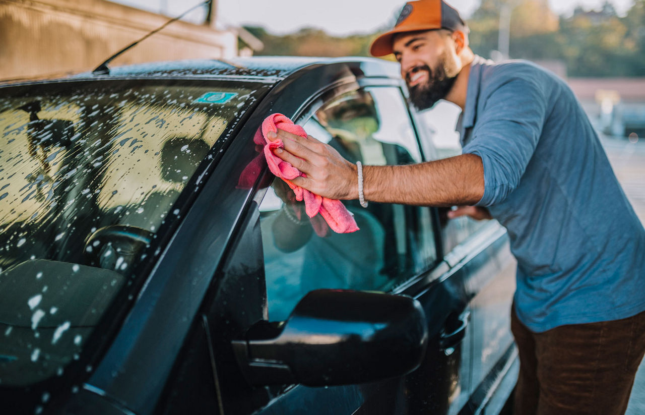 A man drying a freshly washed car