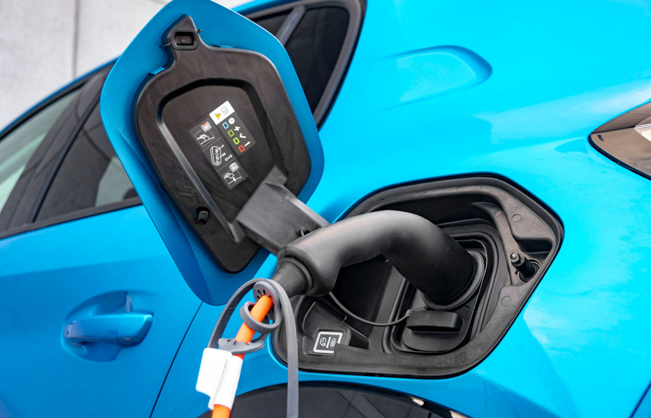 blue vehicle charging it's EV battery.