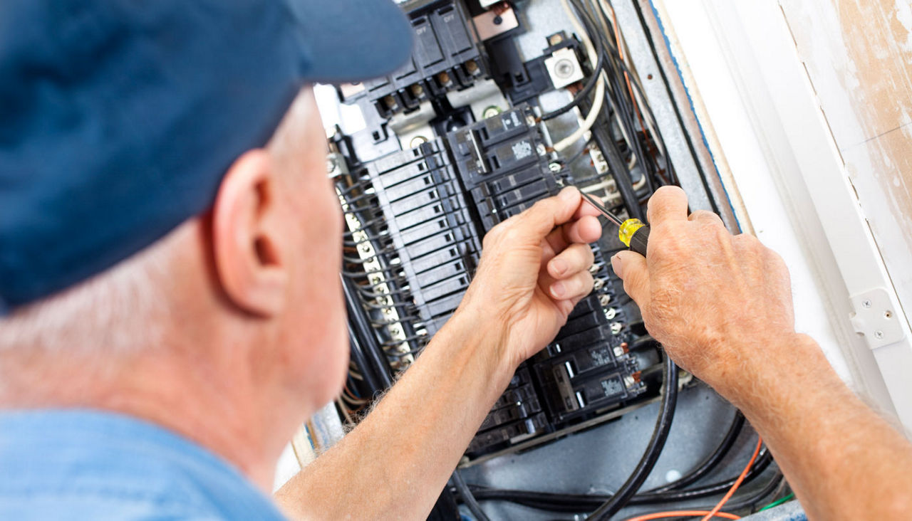 Technician working on electrical panel 