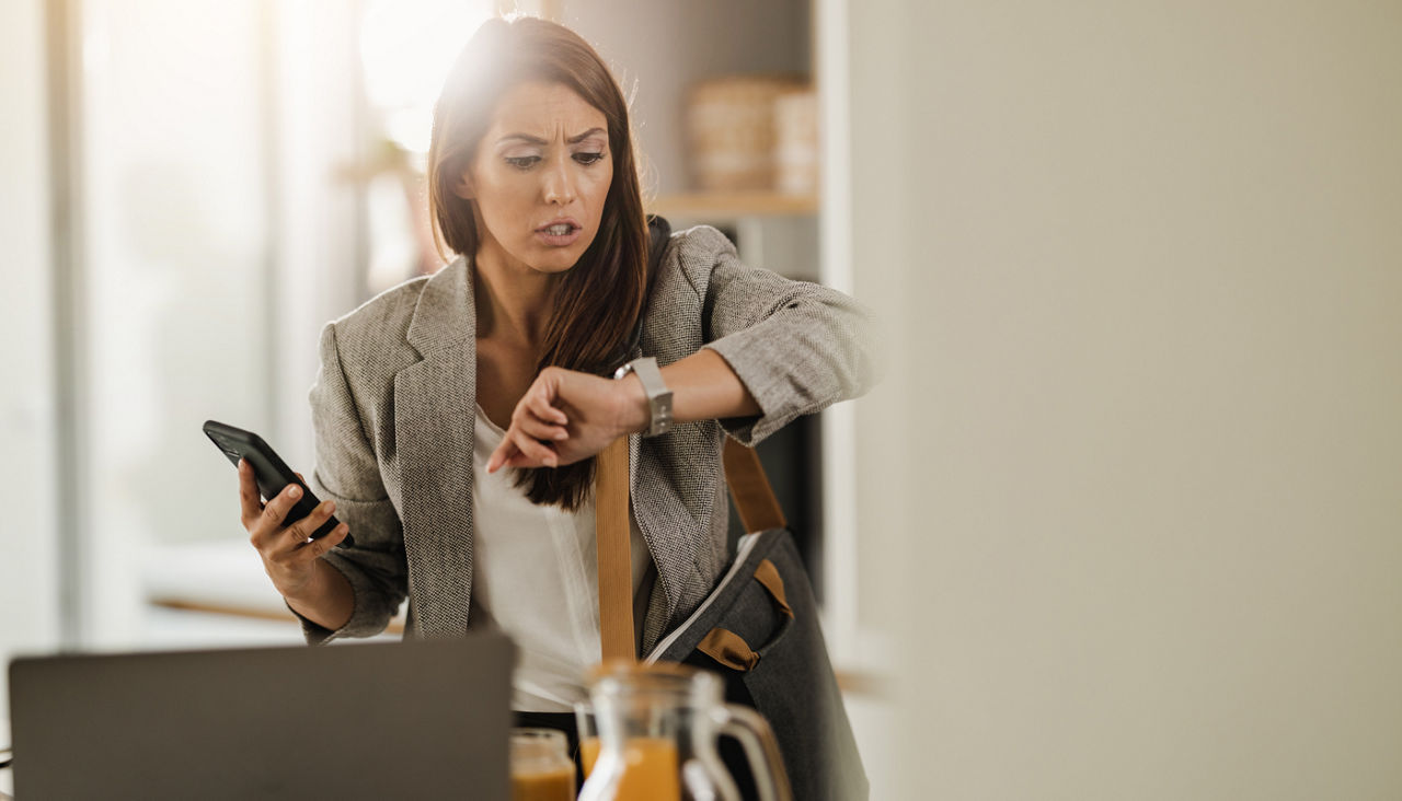 Woman checking her Schedule on a watch at home