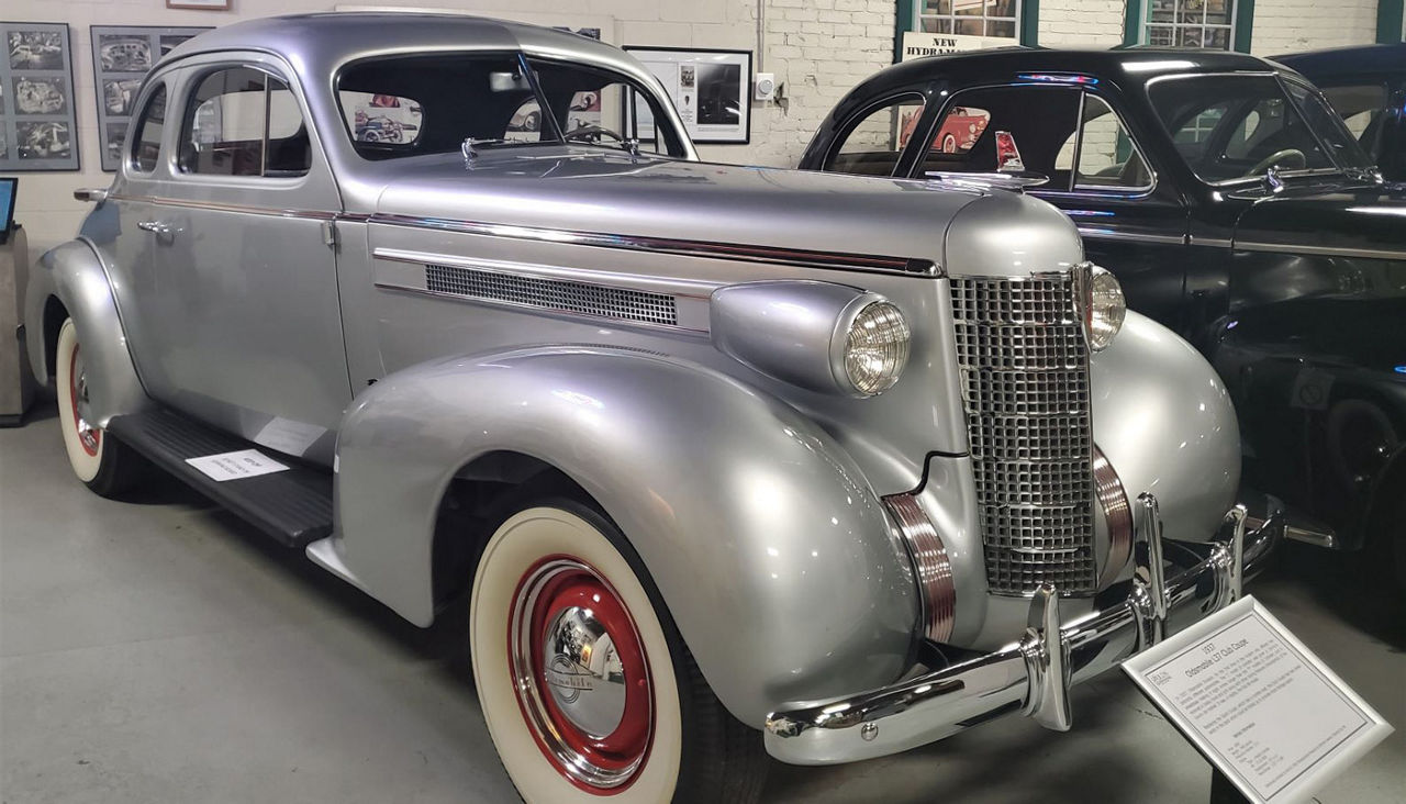 A silver classic car in the R.E. Olds Transportation Museum