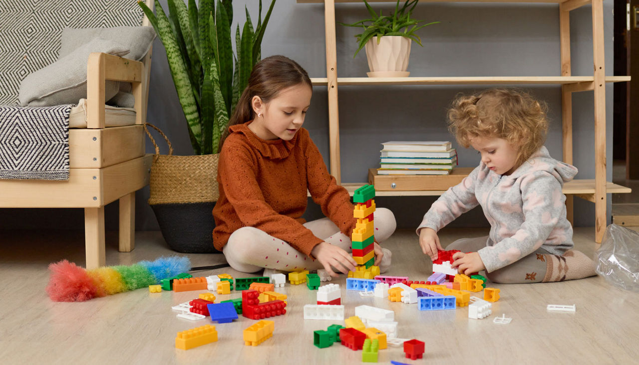 Children playing with blocks on floor in living room