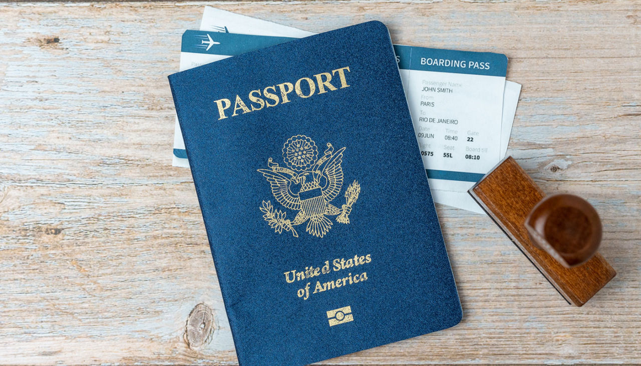 US passport and stamp on wooden background with stamp and boarding passes.