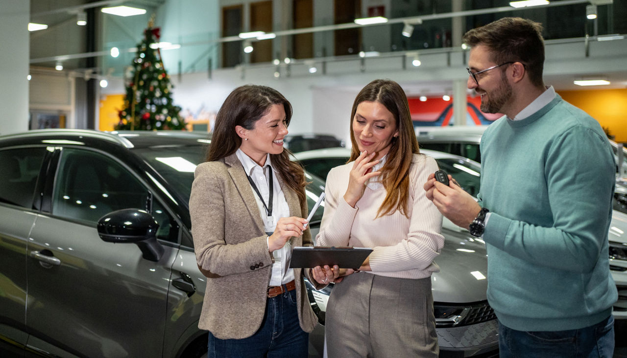 Couple shopping for a new car during the holidays