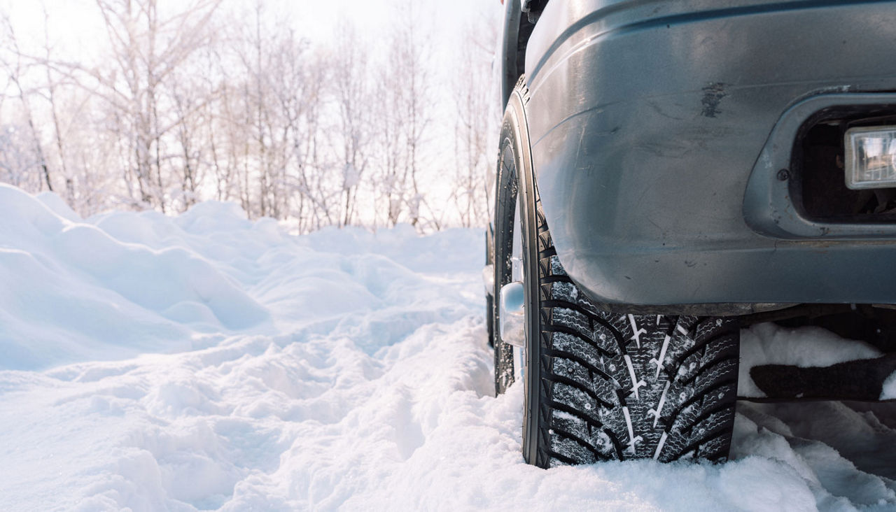 Driving a car off-road in the snow close-up
