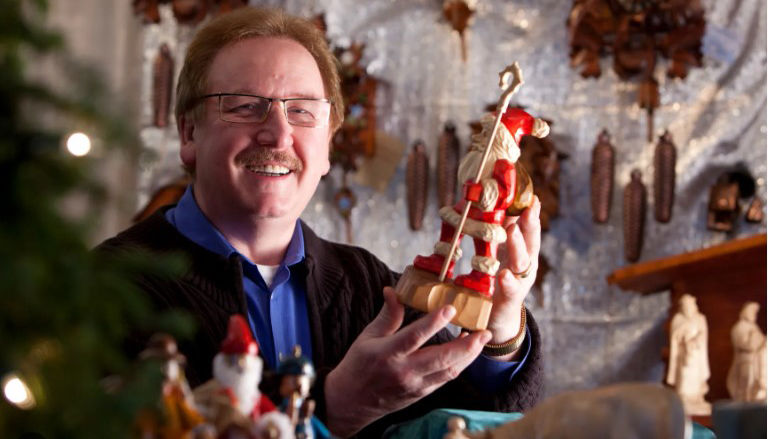 Man holding a Christmas item at the Old World Christmas Market