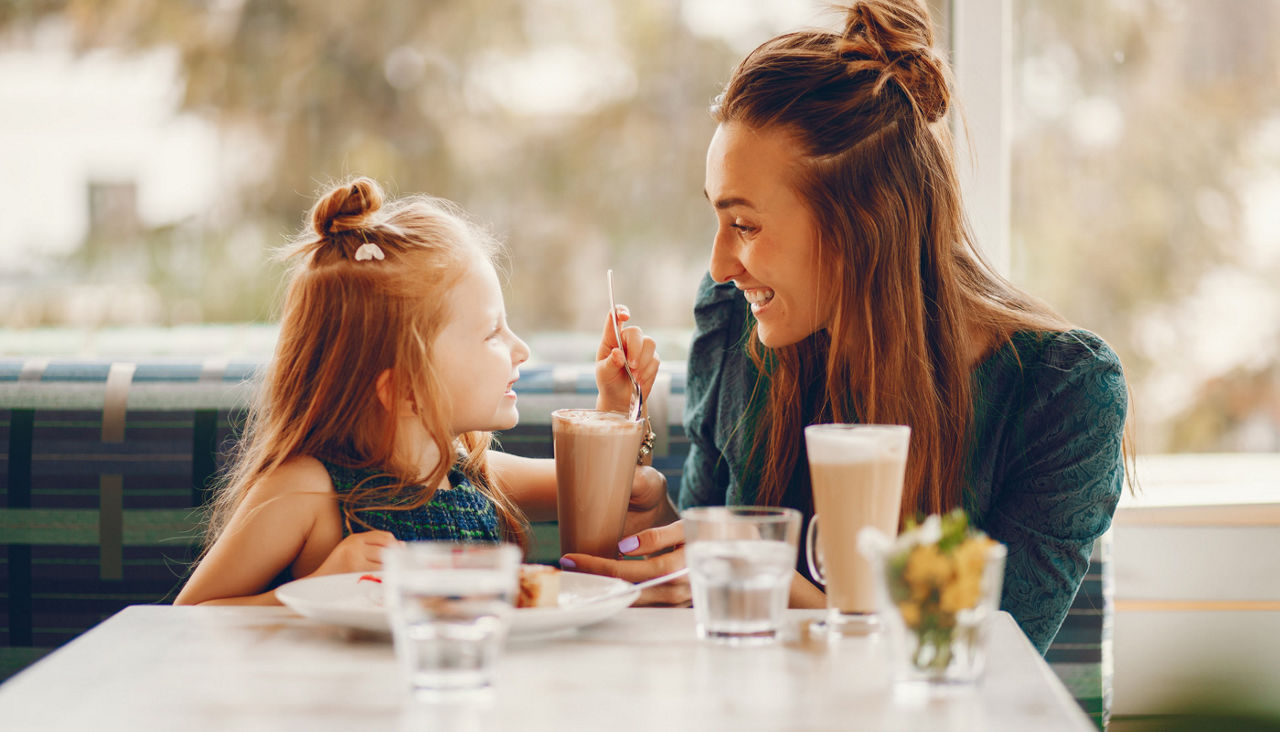 Mother dining with daughter in restaurant