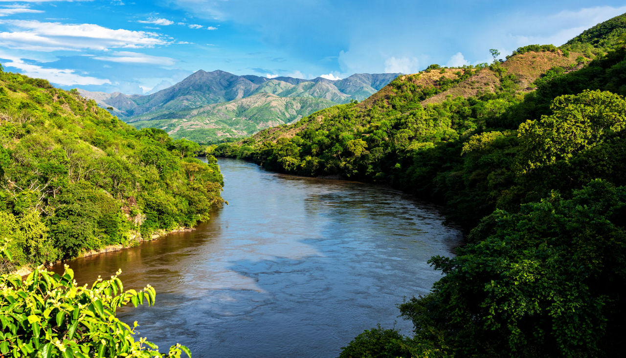 Panoramic view of mountains and highlands in the countryside of Colombia, South America. Beautiful picture of Magdalena river in the foreground