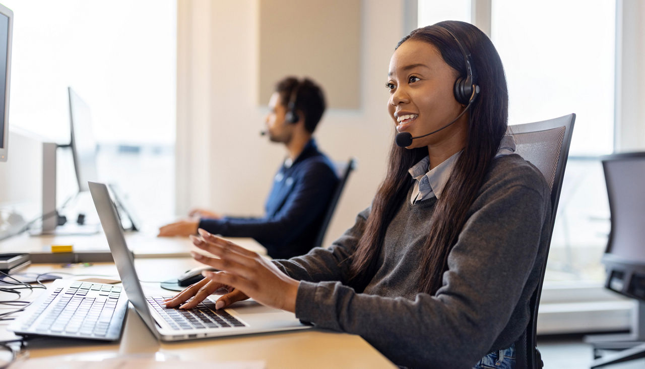 Customer service representative fielding phone calls in office