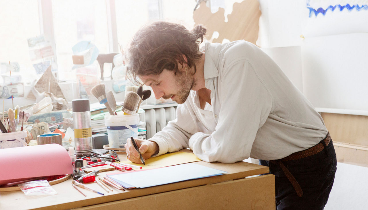 Artist is sketching in his studio