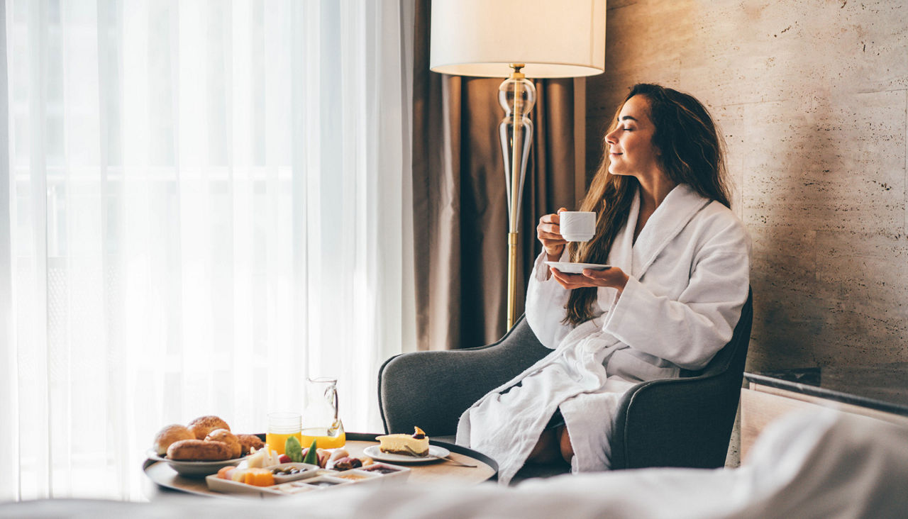 Woman eating breakfast in the hotel room