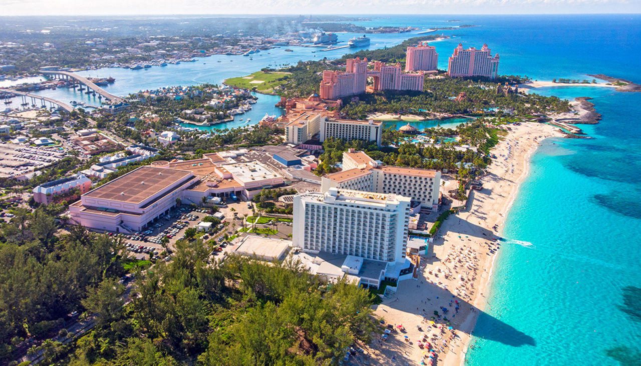 A skyview of hotels by the light blue Carribean waters. 