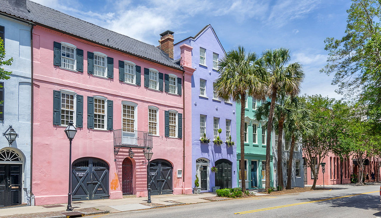 Colorful pastel houses line the street at Rainbow Row