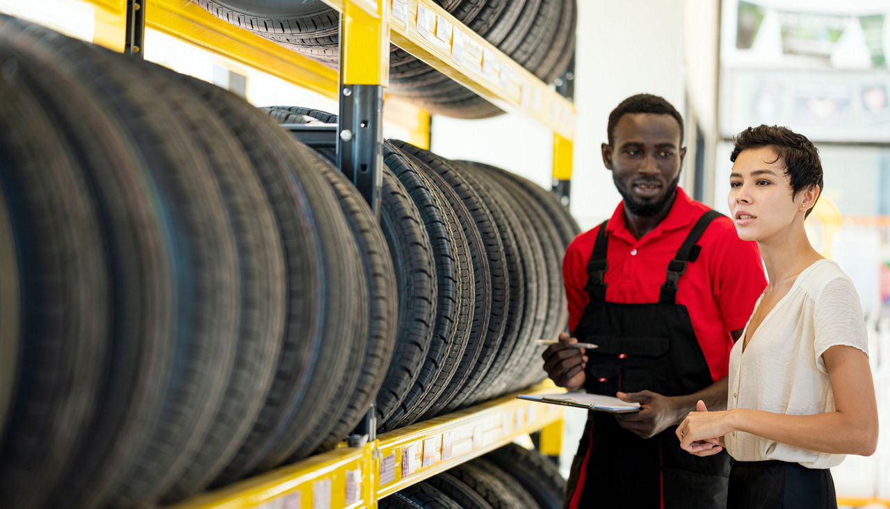 Female customer asks questions about the tires to a specialist of wheel and tire at Auto Repair Center