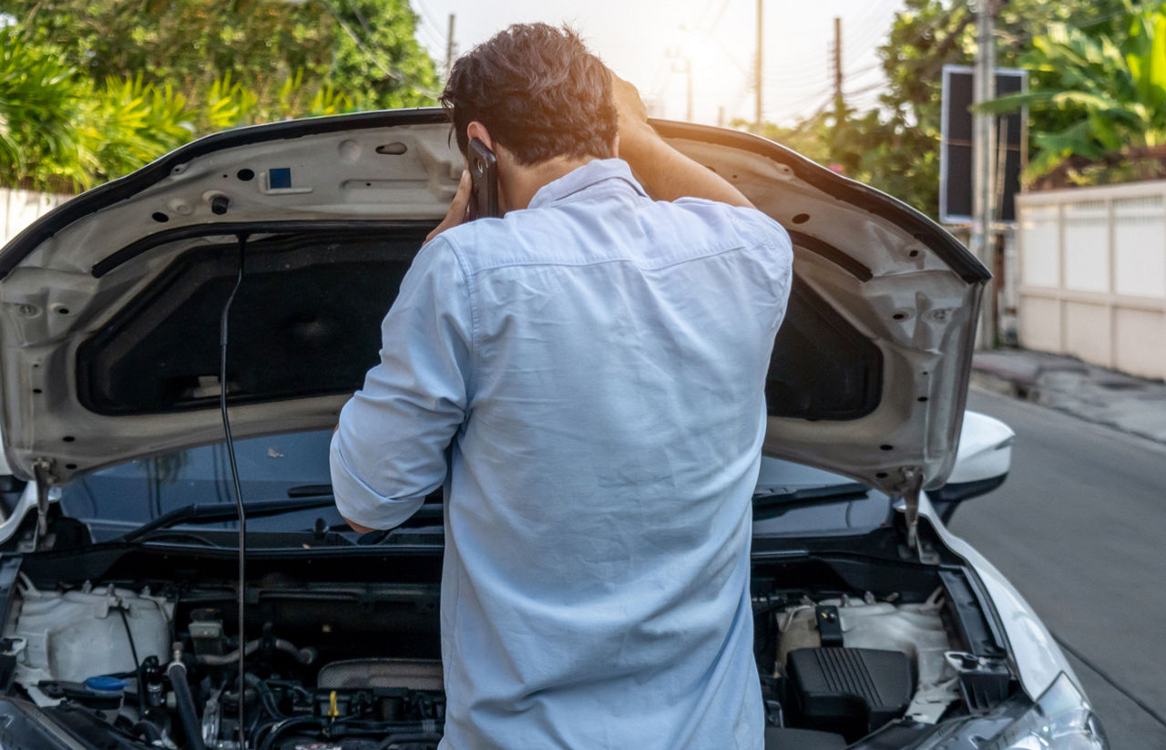  man calling for help form broke down car