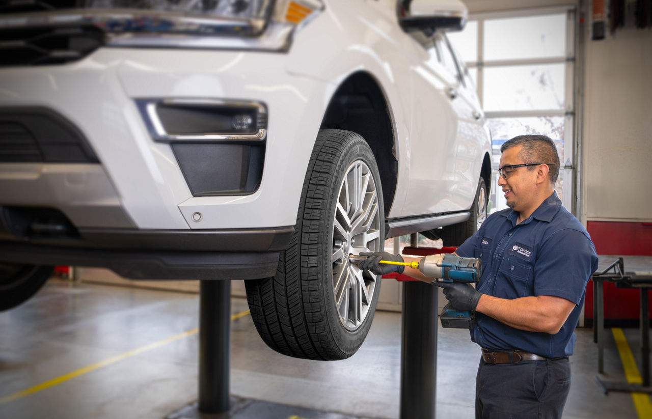 Car technician working on the tires of a car
