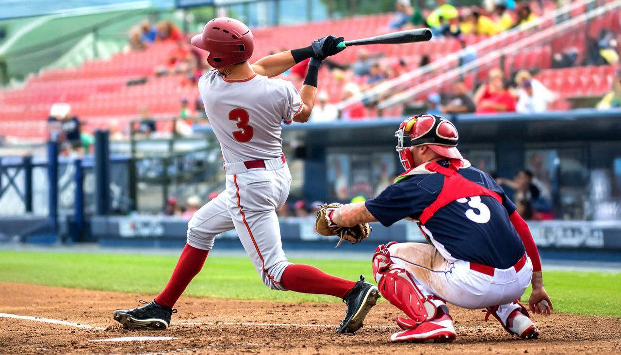 baseball player hitting the ball