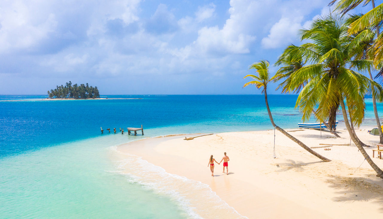 A young couple strolling on a tropical island