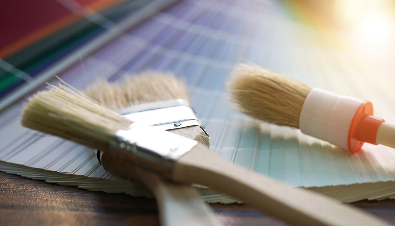 Close up of paint brushes and color samples