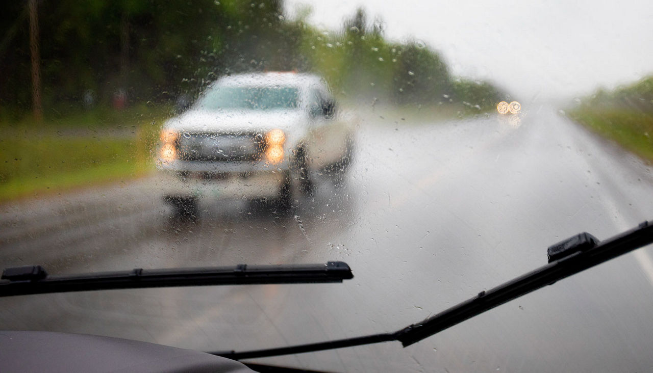 car driving in wet rainy weather