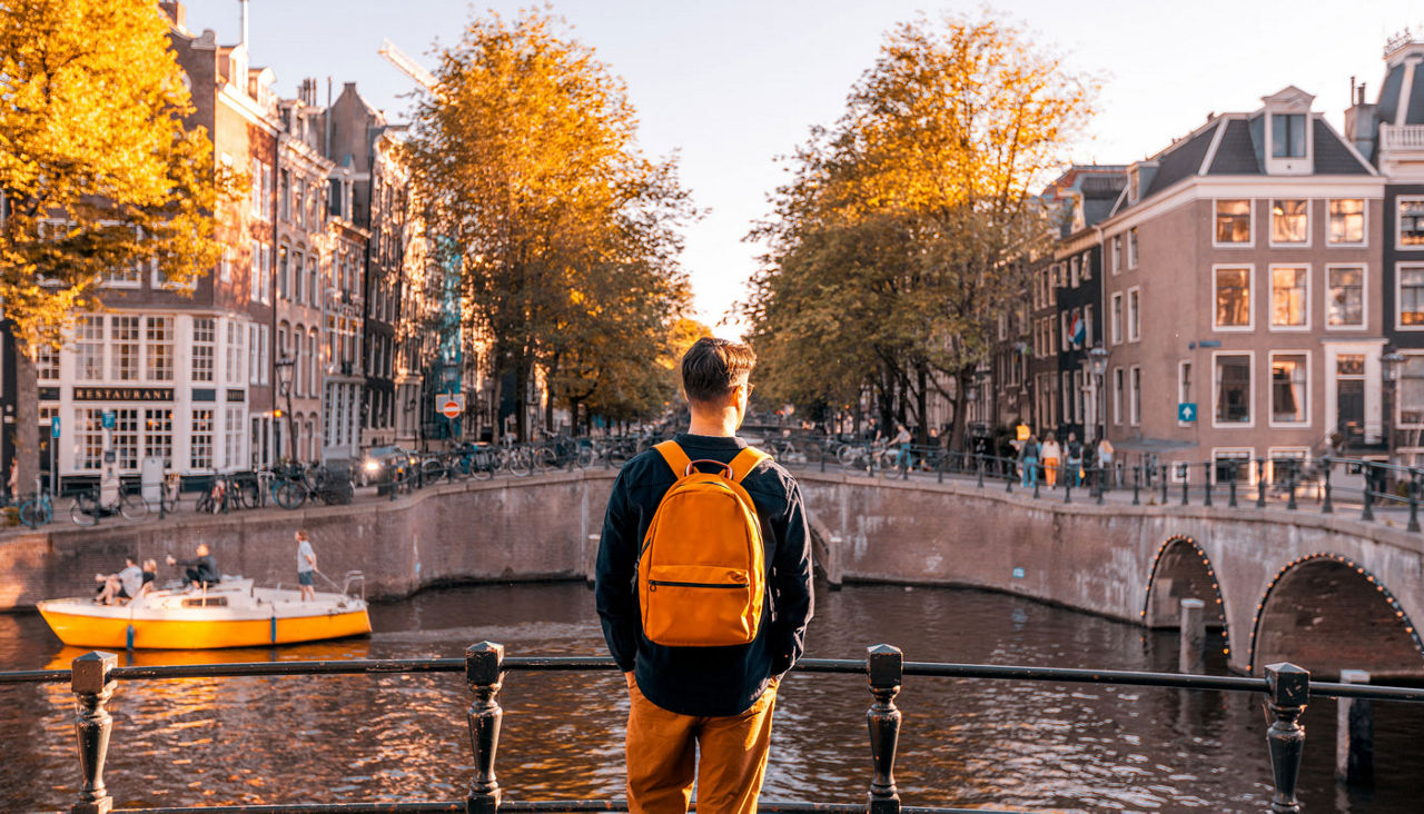 young male taking in the European view off of a bridge