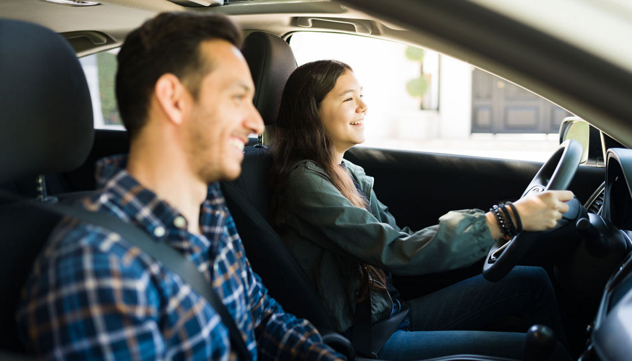 dad and teenage girl driving together