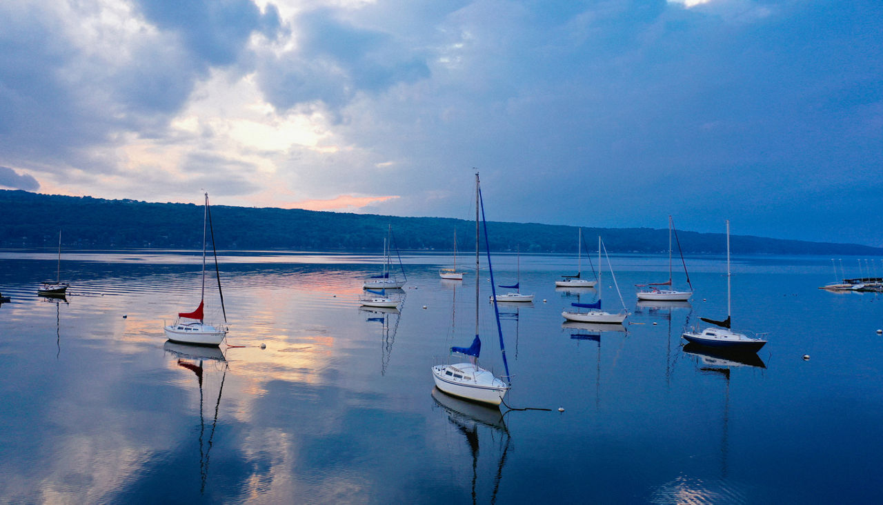 Sail boats sitting in Finger Lakes at sunrise