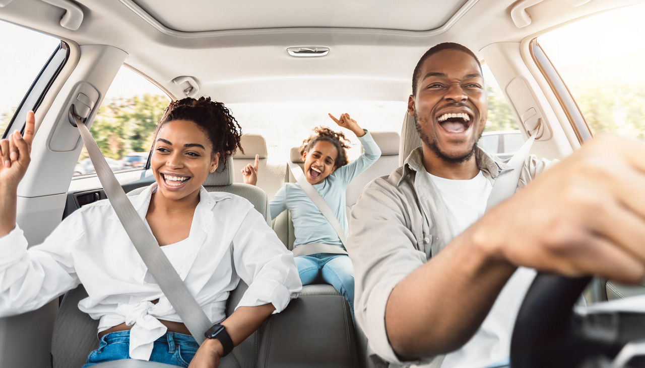 Happy Family Of Three Singing Having Fun Riding in Car