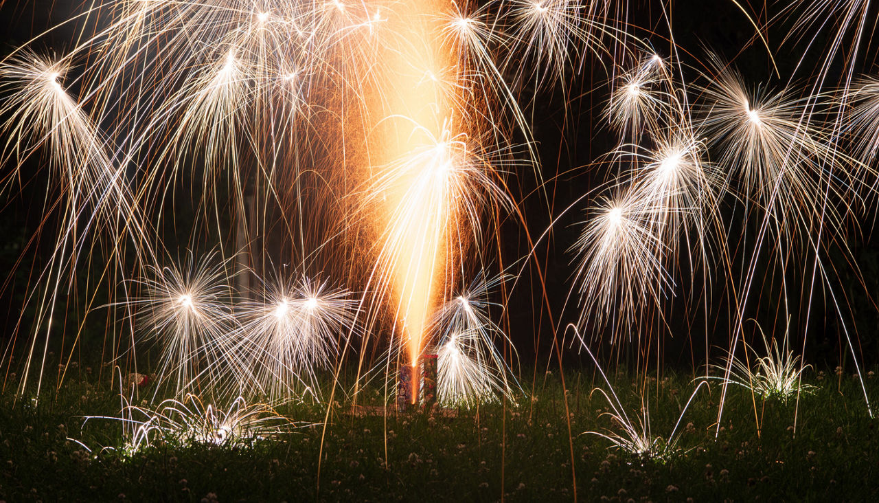 Roman candle shooting off fireworks display on the grass