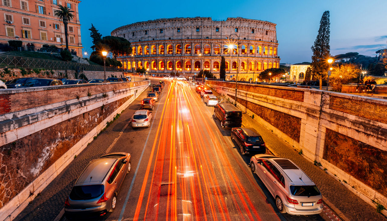 Coliseum and Rome skyline illuminated at dusk, elevated view, Lazio, Italy