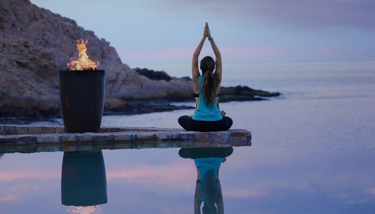 Woman enjoying peaceful yoga somewhere on the coast of Los Cabos
