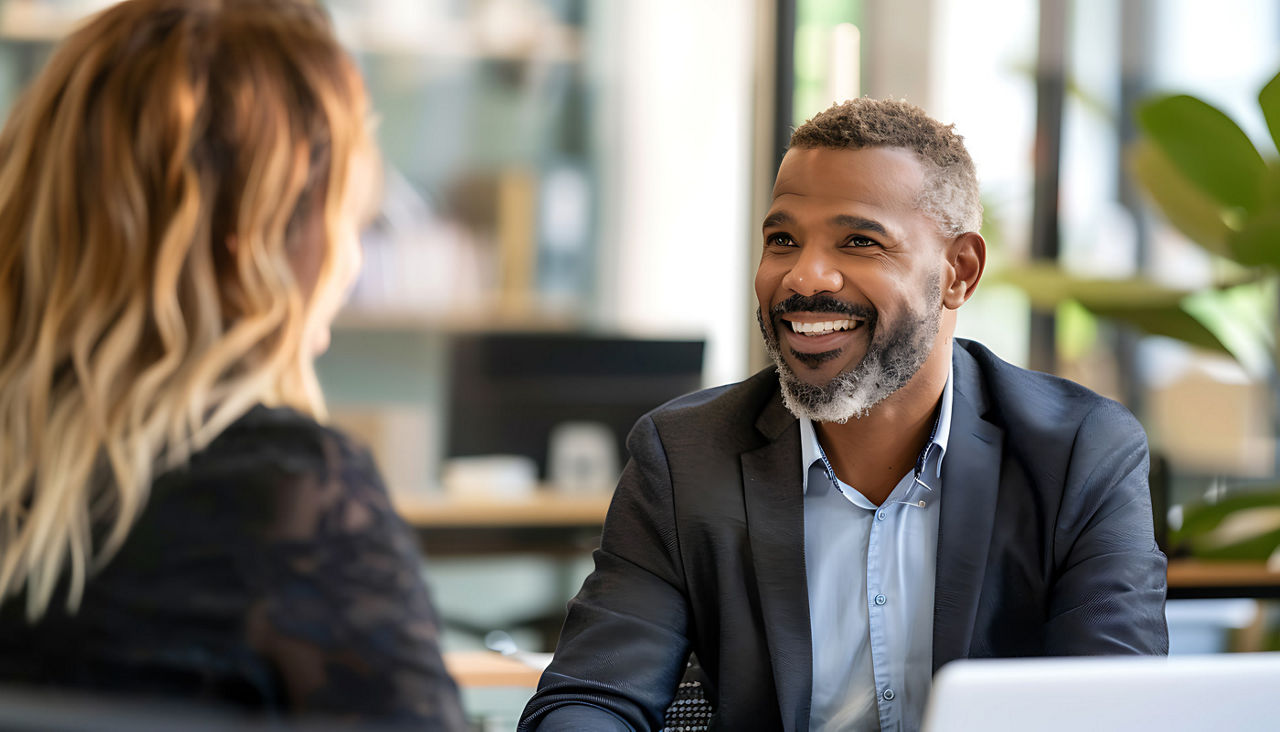 In-Person Interviews in Modern Conference Room: Interviewer and Candidate with Portfolio