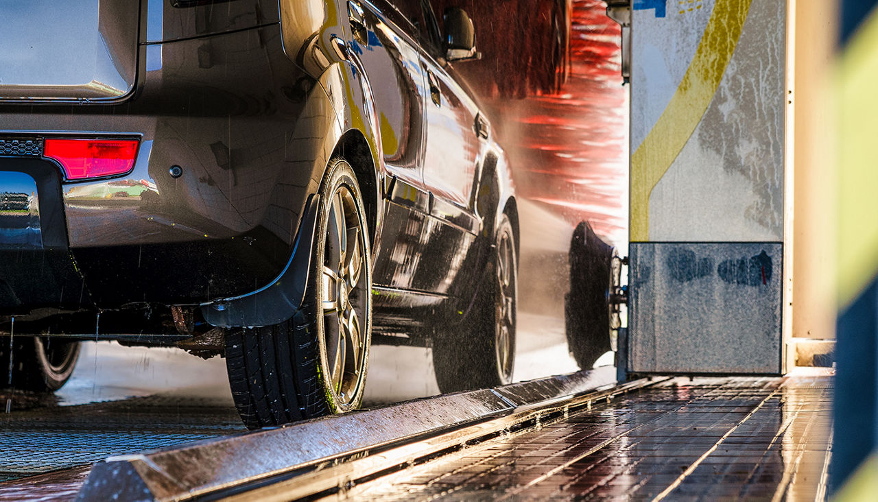 Cleaning of car in automatic car wash.