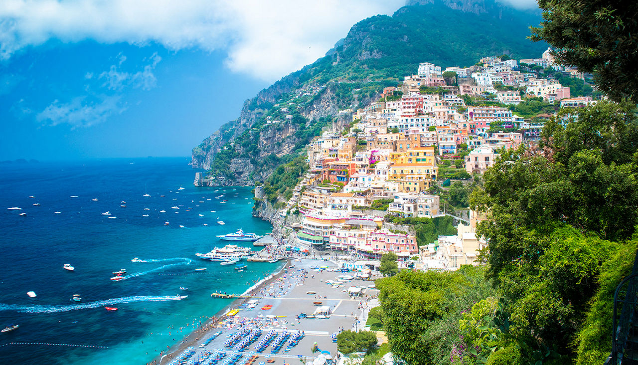 The colorful seaside town of Positano looms over the water. 