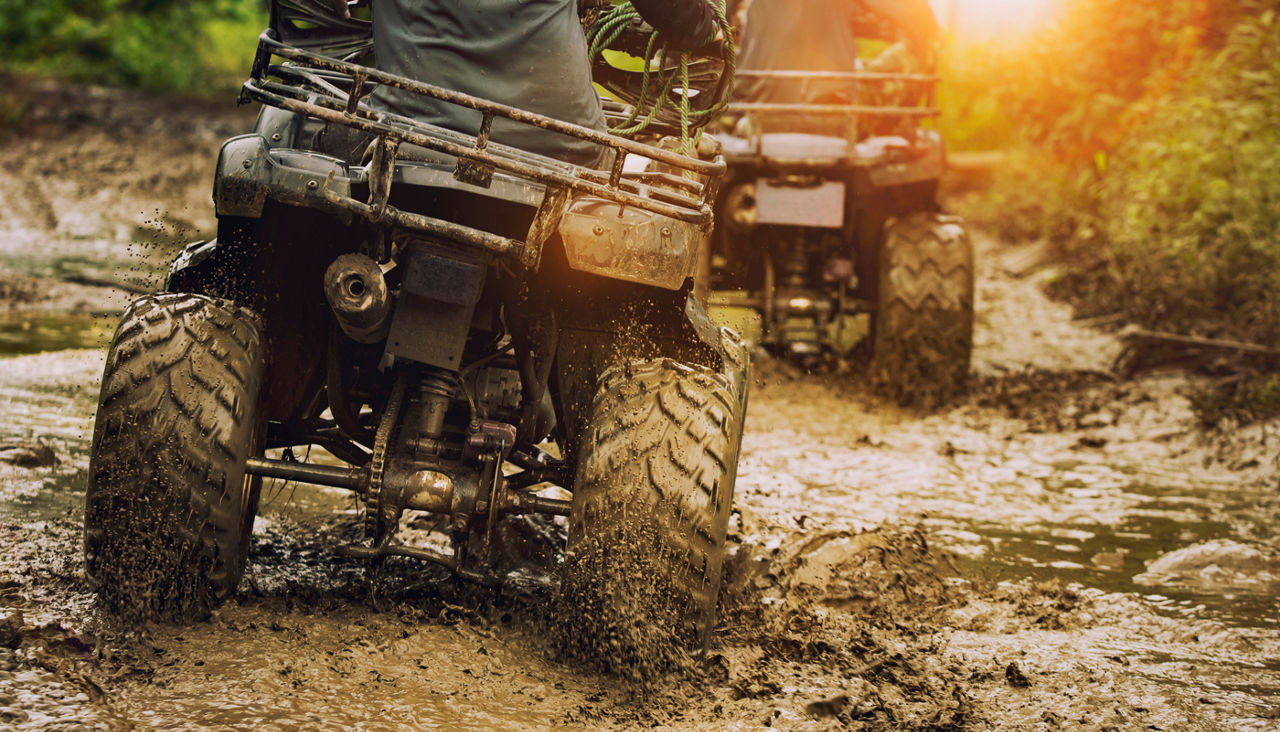 man riding atv vehicle on off road track