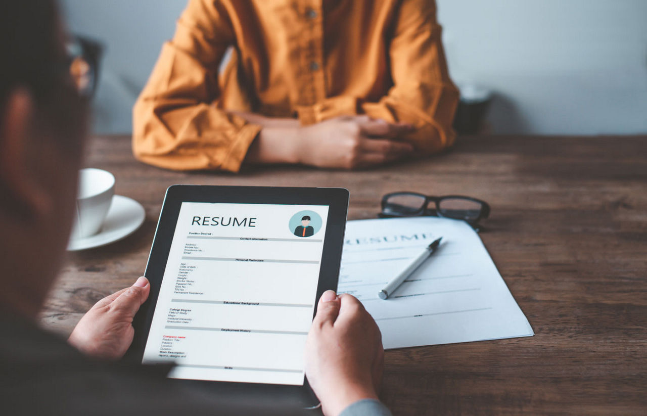 HR managers are interviewing job applicants who fill out their resume on the job application form in order to consider accepting a job as a company