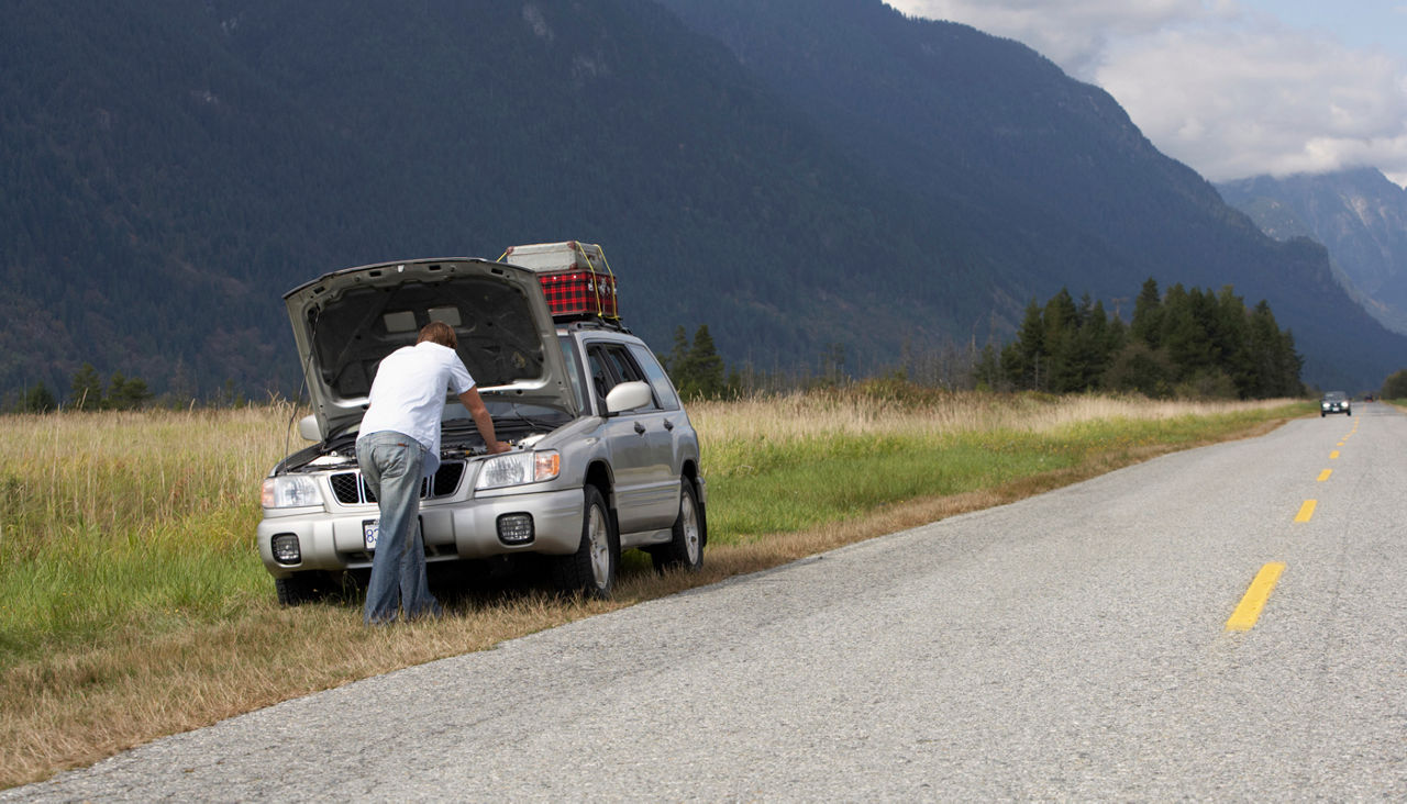 Man on side of road with engine trouble
