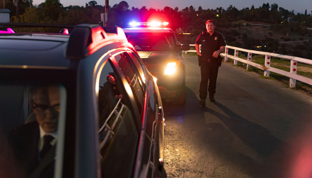 Police Officer Walks Up to Car Pulled Over for Traffic Stop