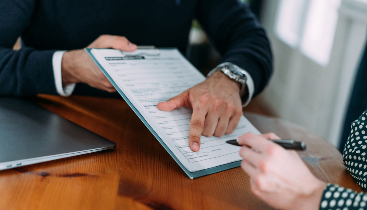 Business people signing a contract in the office