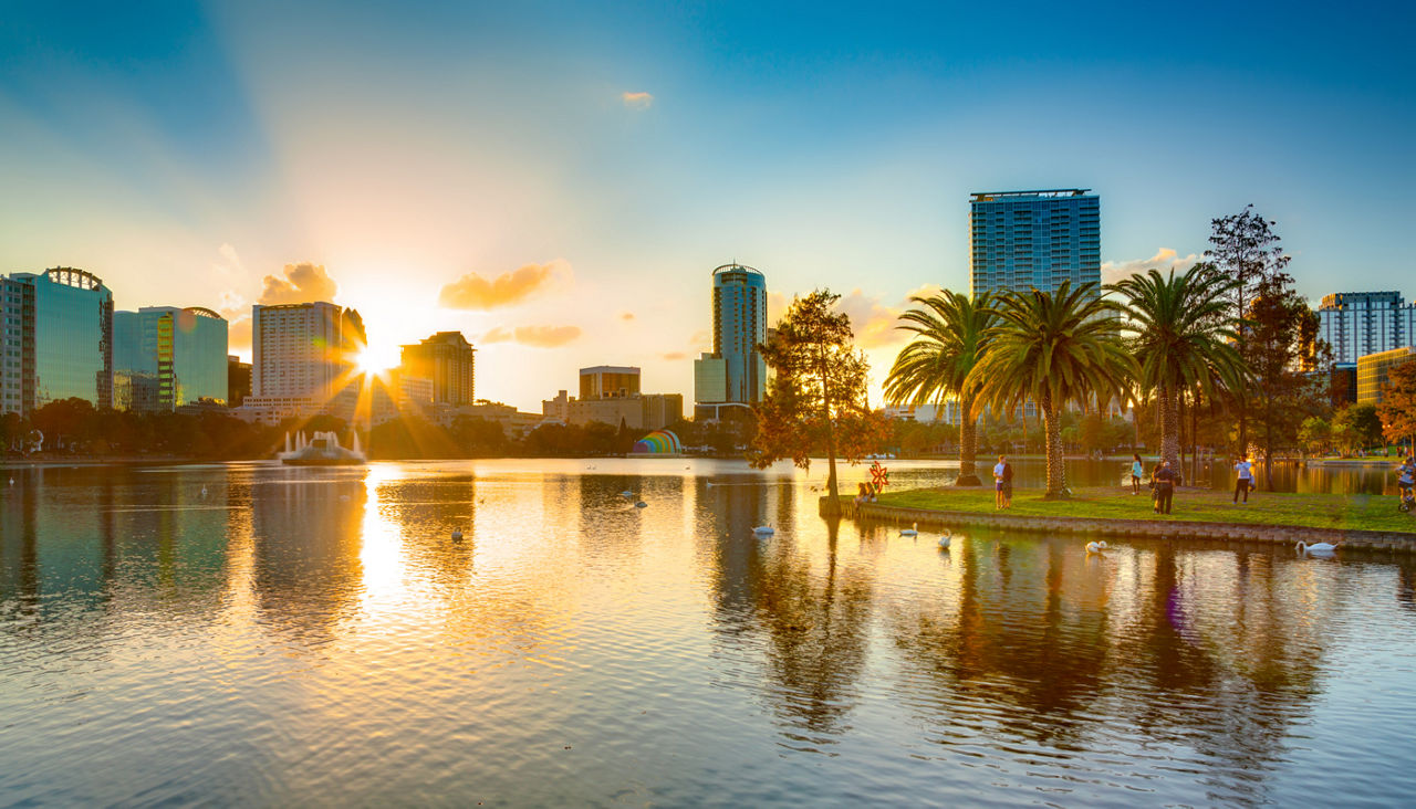 Sunset at Orlando in Lake Eola Park with water fountain and city skyline, Florida